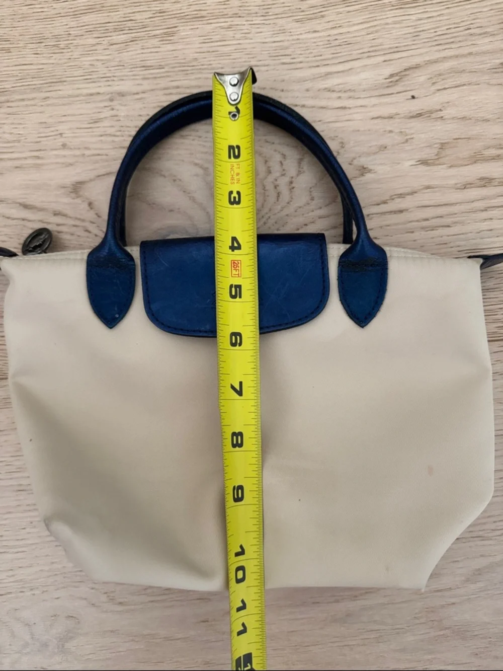 Longchamp Small Le Pliage Cream Tote with Navy Trim. Top zip with snap flap.